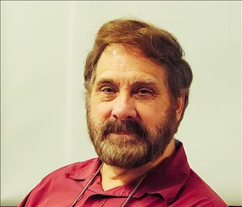 man with light brown hair and a red shirt